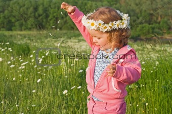 Little girl playing with flower petals