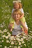 Woman and little girl on the daisy field