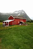 Red barn surrounded by norwegian nature