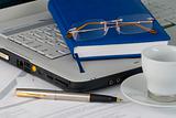White laptop, diary, glasses