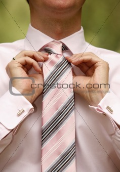 Man tying necktie