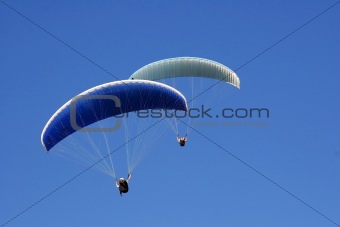 Paraglider on a blue sky.