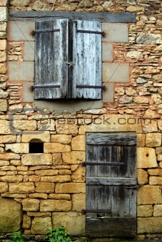 The closed windows, doors and shutters in an old wall (2)