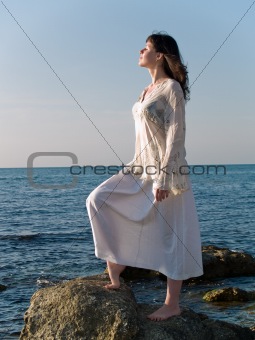 Young Woman on Sea Stone Looking Straight