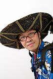Asian tourist with mexican hat and backpack.