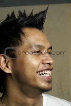 Laughing asian punk man portrait