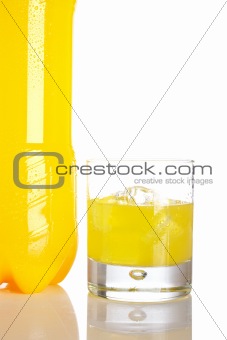 Bottle and glass of orange soda with droplets