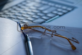 White laptop and glasses
