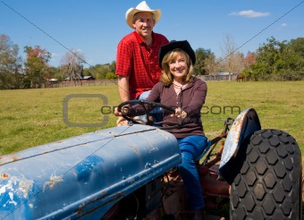 Mature Farm Couple on Tractor