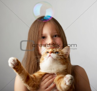 Small girl with a red cat
