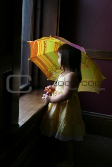 Little girl with yellow umbrella