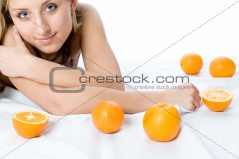 Portrait of young woman with two orange