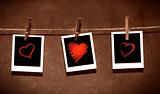 Photo paper attach to rope with clothes spins on grunge  background/ Valentine theme
