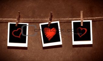 Photo paper attach to rope with clothes spins on grunge  background/ Valentine theme