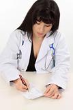 Female doctor writing a script for medicine