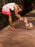 Black woman dancing with Pomeranian Spitz dog (focus on dog)