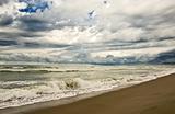 empty beach diring a storm with heavy clouds