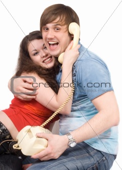 The young couple with old phone. Funny picture. Isolated 