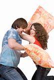 The young couple fights pillows. Isolated