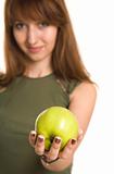 Fitness girl with green apple, focus on fruit