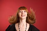 Beautiful red-haired girl shaking her hair