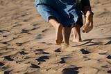 Barefoot legs on the sand beach