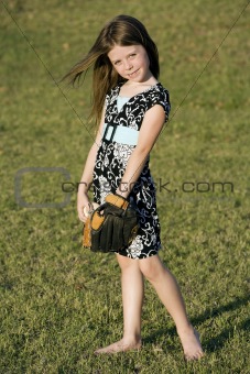 Cute young girl with a baseball
