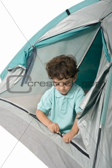 young boy in a tent