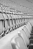 Rows of grey empty stadium seats