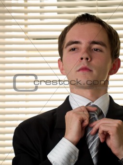 Yound businessman ties necktie