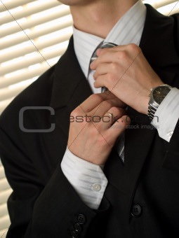 Young buisnessman ties necktie