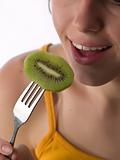 Teen eats kiwi