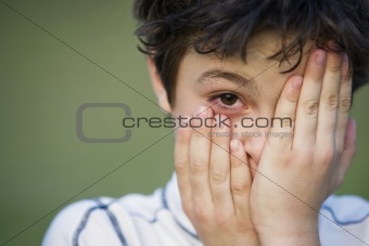 Young Boy Covering His Face