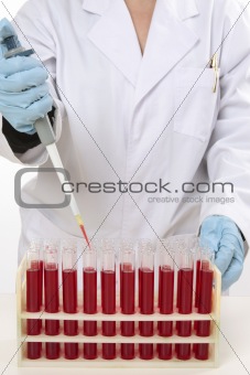Scientist using pipette to extract samples
