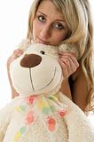 Lovely young blonde girl with teddy bear