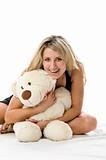 Lovely young blonde girl with teddy bear