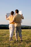 Couple with map in a meadow