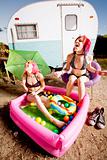 Women in a play pool playing with bubbles