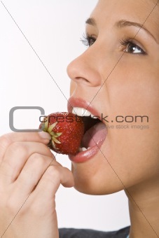 Bitting into a strawberry
