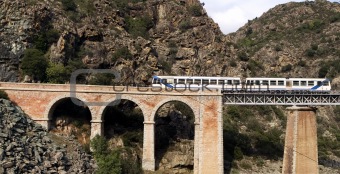 Train on the bridge through a precipice, Corsica