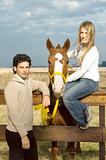 Young couple posing with their horse