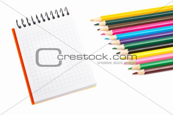 Blank notebook and coloured pencils 