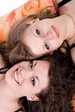 Portrait of the two beauty young women laying on a pillow 3