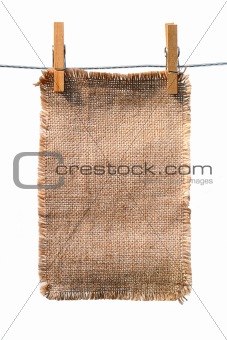 burlap canvas with lacerate edges hanging with wooden pegs