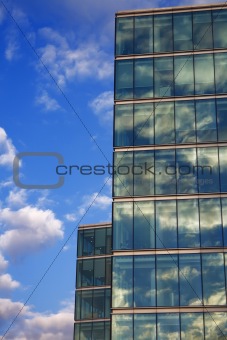 blue sky reflection on glass modern Corporate building