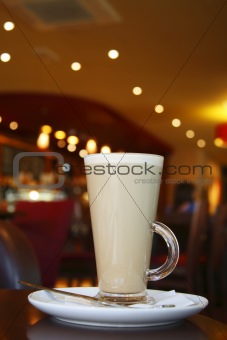 Coffee - Latte Cappuccino in a tall glass on cafe background