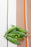 fresh green peas on tablecloth background