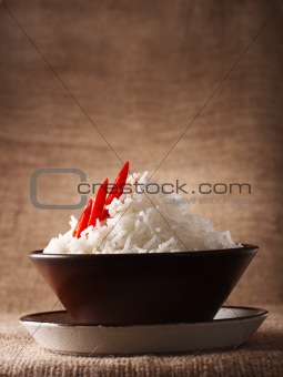 rice bowl with fresh chillies on brown rustic background