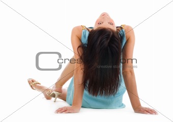Beautiful young woman sitting on a floor