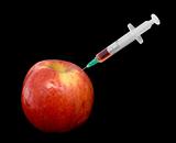 Red apple with a syringe